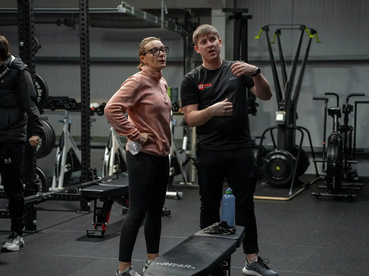 A Reid Fitness coach talking a member through a session